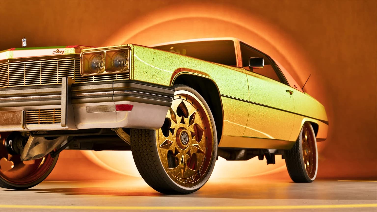 A gold custom lowrider on wire wheels lit from behind in a workshop